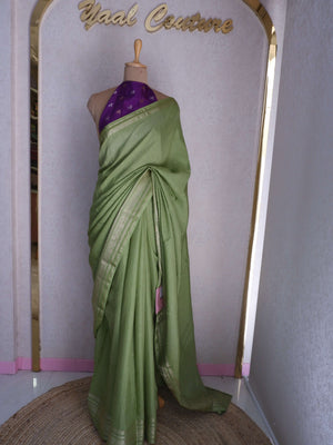 Green saree with a purple blouse