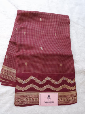 Maroon fabric with gold patterns