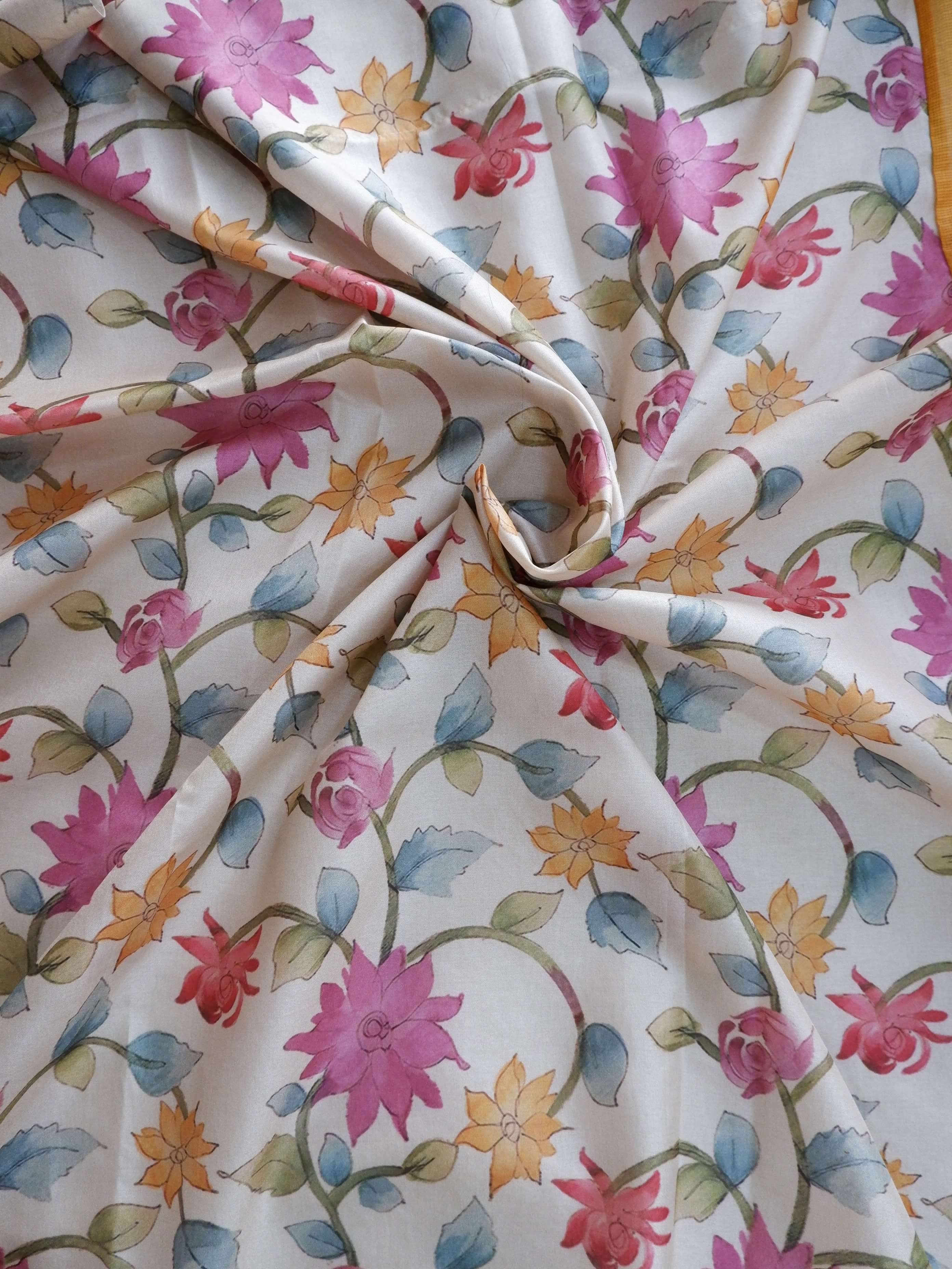Floral patterned fabric with pink, blue, and orange flowers 