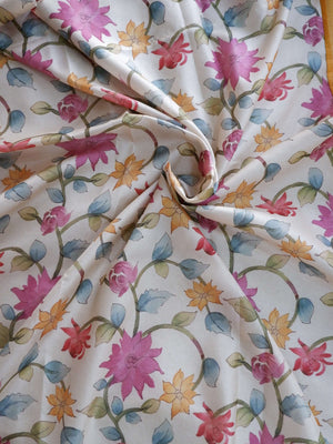 Floral patterned fabric with pink, blue, and orange flowers 