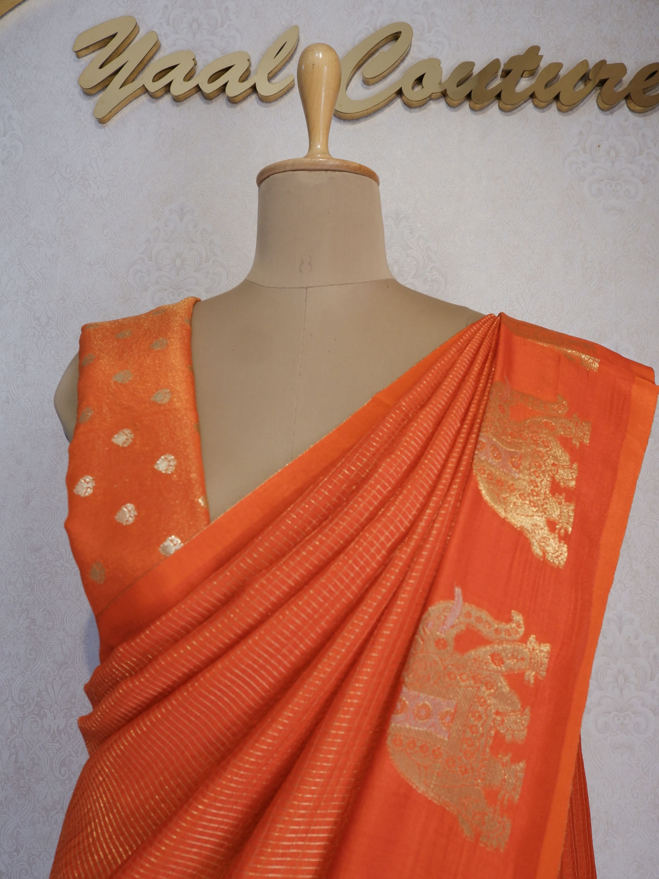 Orange saree with gold patterns 