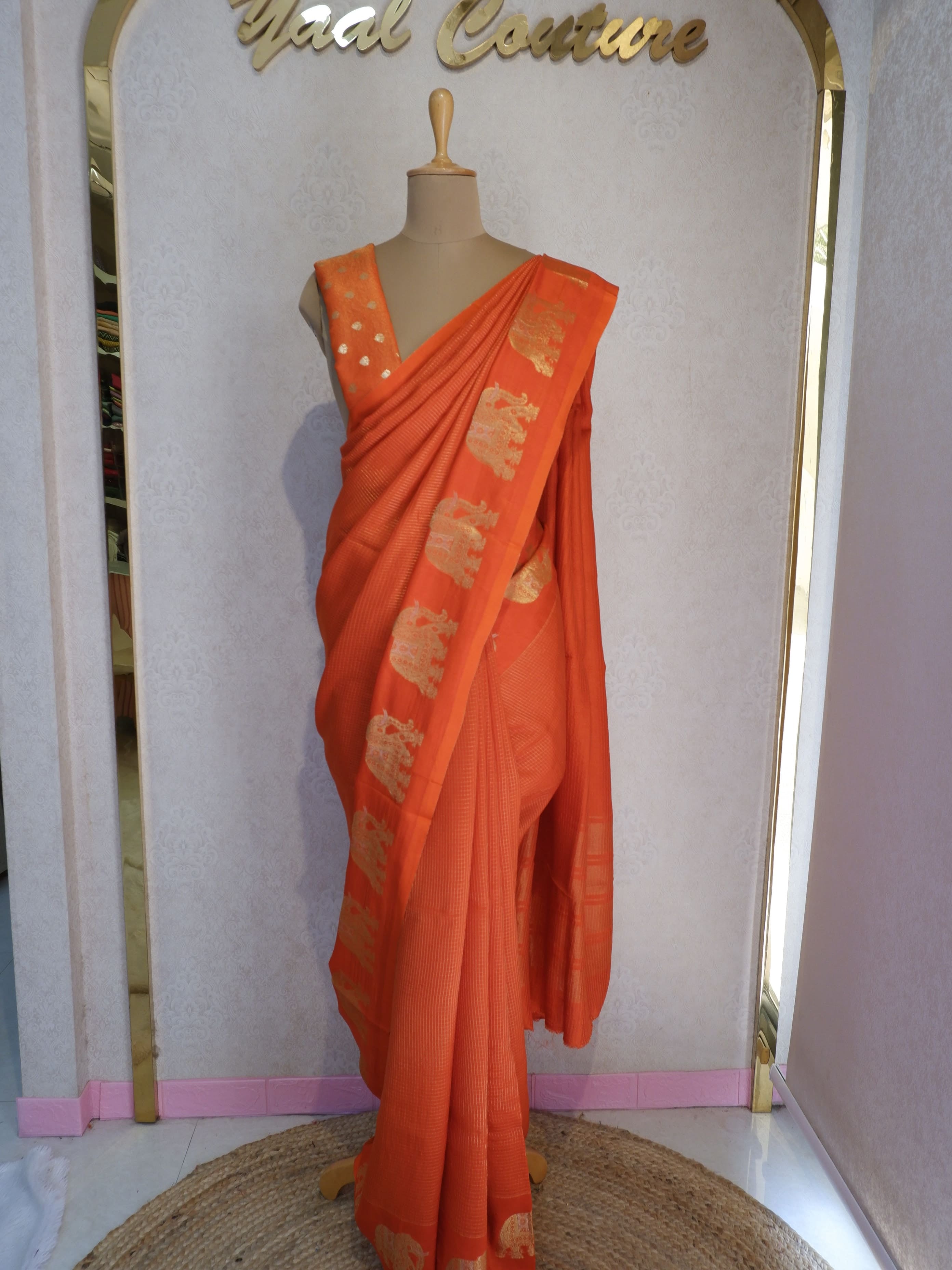 Orange saree with gold patterns