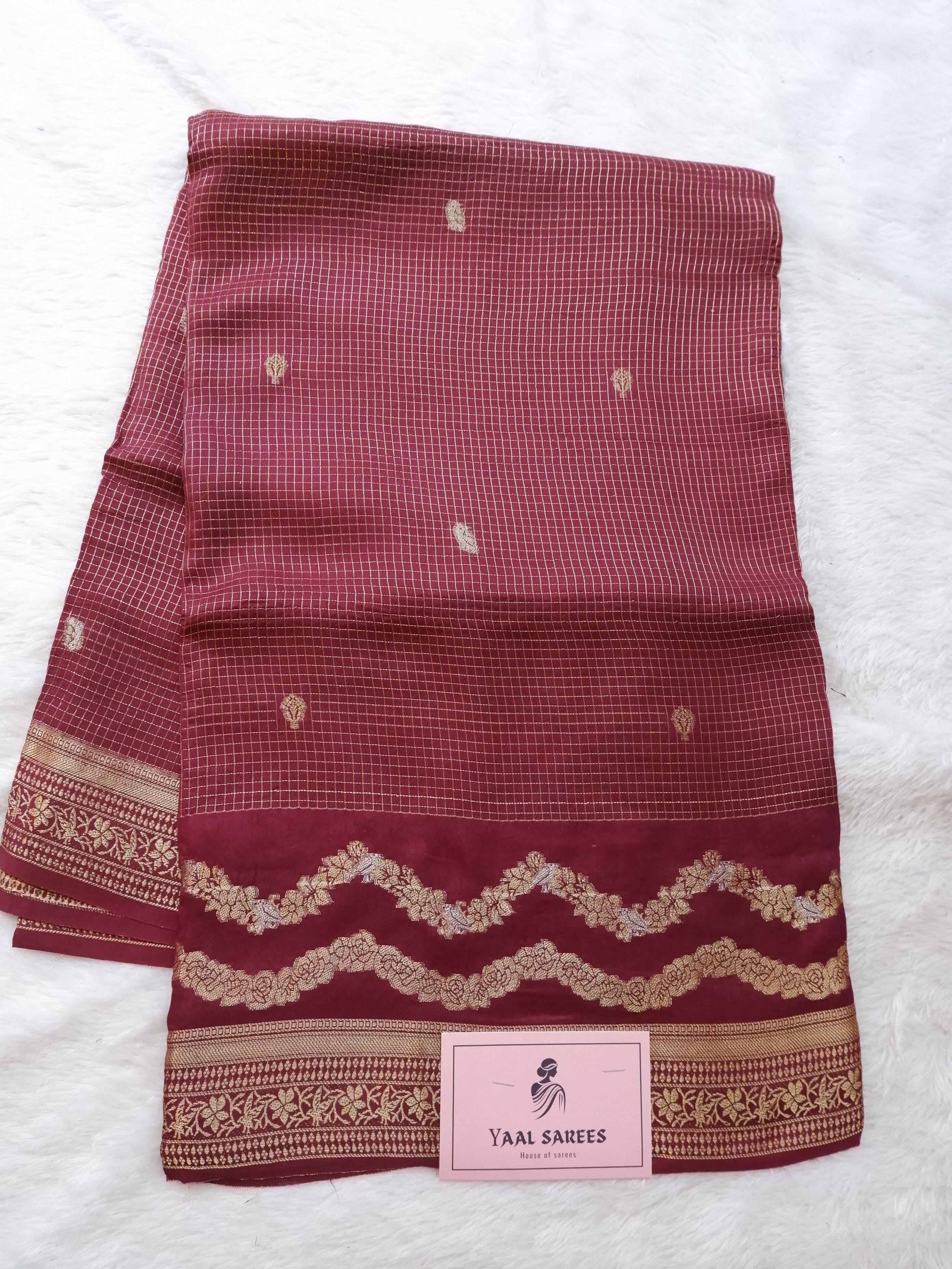 Maroon fabric with gold patterns 